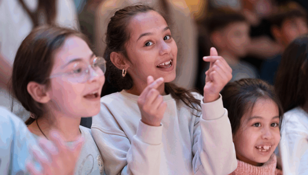 Kinder singen und schnippen zur Musik bei The Power of Music.